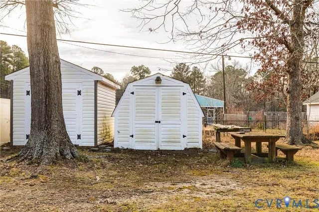 a view of a small house next to a yard