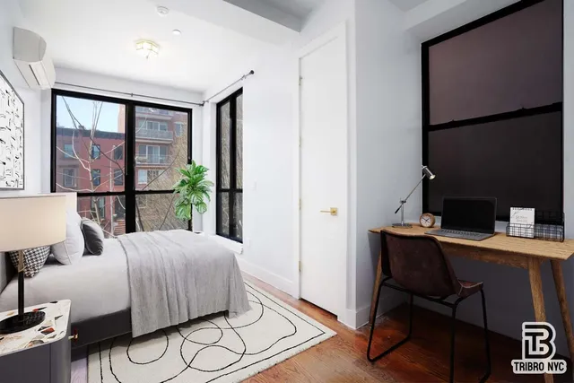 a bedroom with a large bed and a window