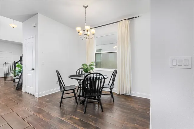 a view of a dining room with furniture wooden floor and a chandelier