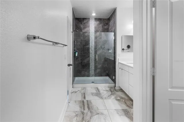 a bathroom with a glass shower door