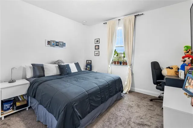 a bed room with a bed and a chair