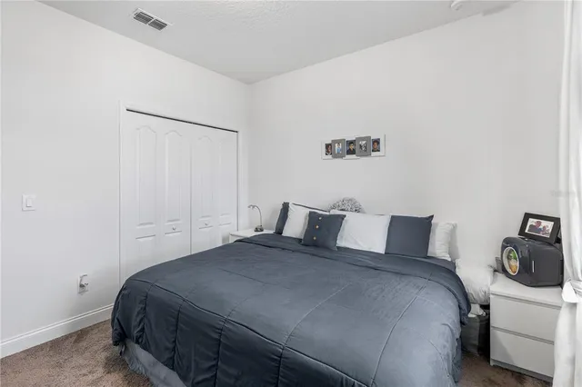 a bedroom with a bed and walk in closet