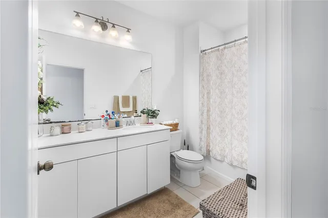 a bathroom with a sink toilet a mirror and shower