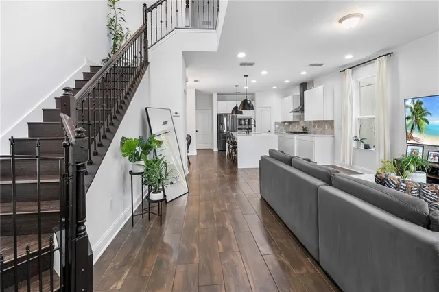 a living room with furniture and a potted plant
