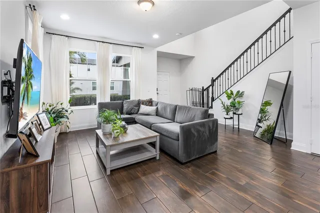 a living room with furniture and a flat screen tv