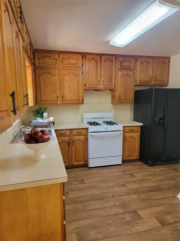 a kitchen with a stove a sink and a refrigerator