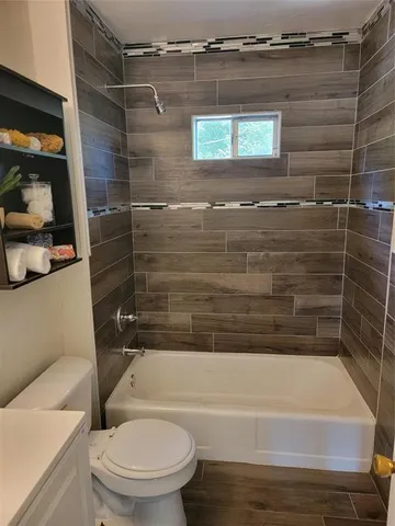 a bathroom with a toilet and a shower