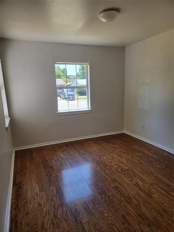 2223 Anderson Street Irving, TX 75062 - Photo 9 of 9 an empty room with wooden floor and windows