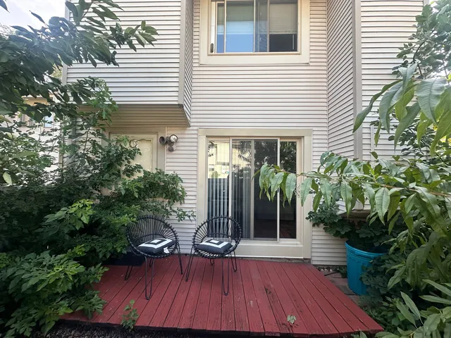 a view of house with patio outdoor seating and plants