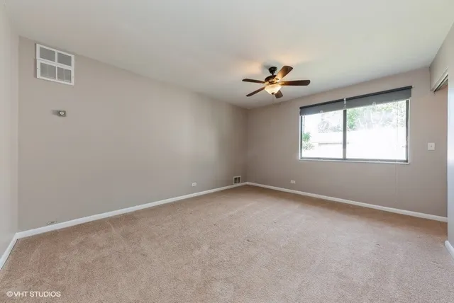 a view of room with a ceiling fan and window