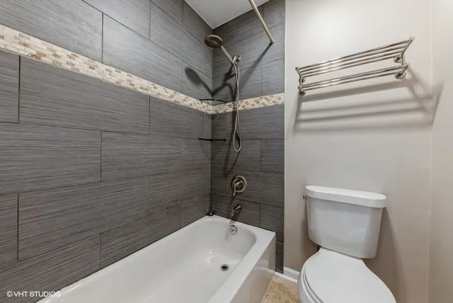 a bathroom with a toilet and shower