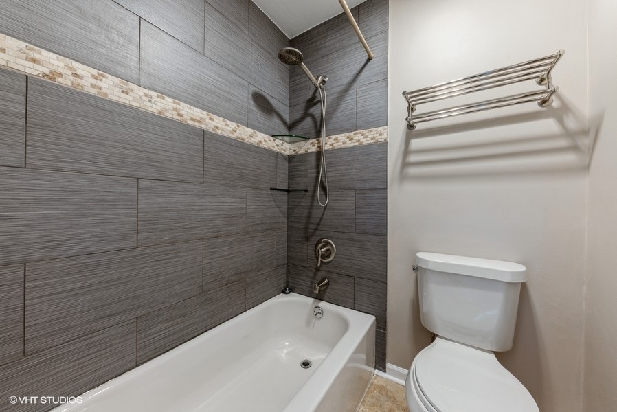 1030 Emerald Drive Schaumburg, IL 60173 - Photo 8 of 13 a bathroom with a toilet and shower