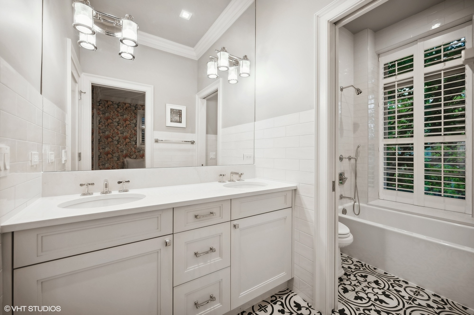 1855 North Dayton Street Chicago, IL 60614 - Photo 29 of 51 a bathroom with a double vanity sink a large mirror and a shower
