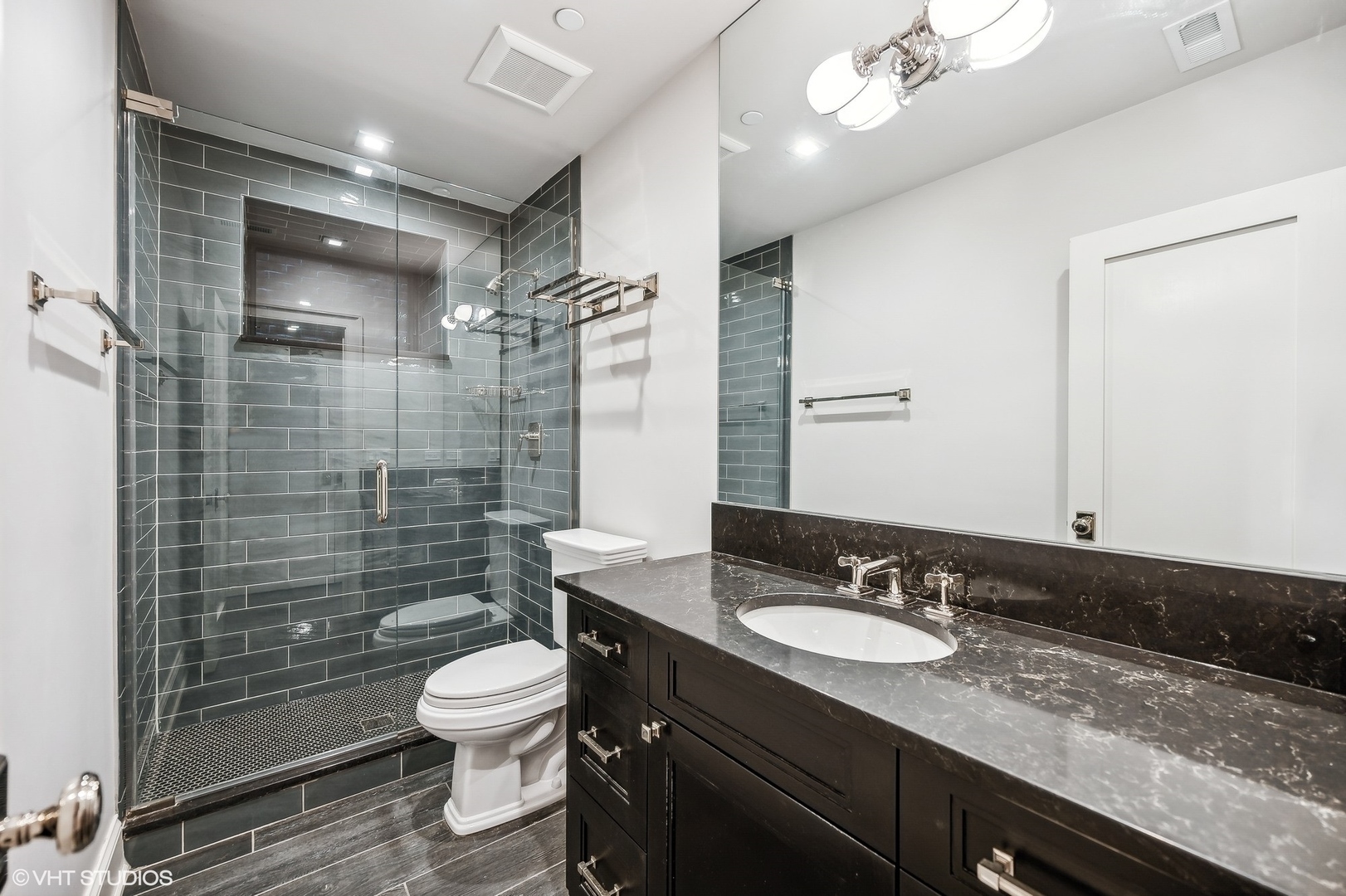 1855 North Dayton Street Chicago, IL 60614 - Photo 49 of 51 a bathroom with a granite countertop sink toilet a mirror a glass door shower and a mirror