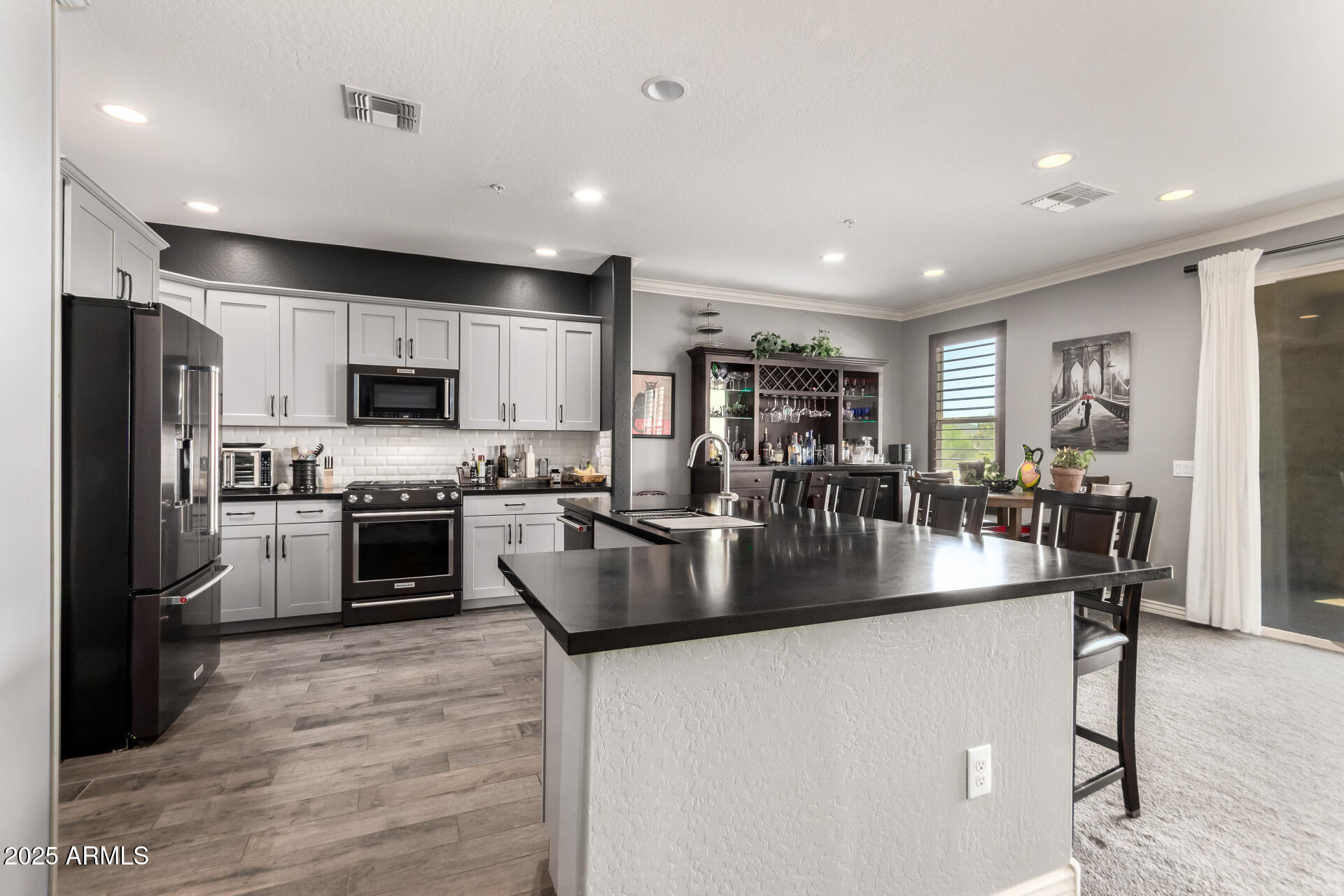 2425 West Bronco Butte Trail, Unit 2028 Phoenix, AZ 85085 - Photo 19 of 46 a kitchen with stainless steel appliances granite countertop a refrigerator a stove and a sink