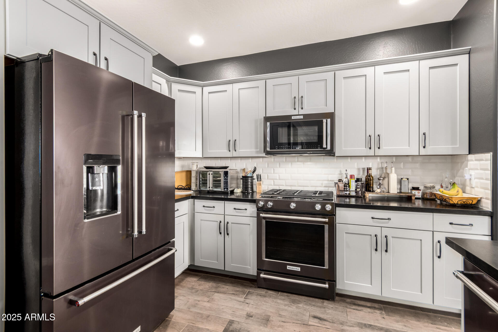 2425 West Bronco Butte Trail, Unit 2028 Phoenix, AZ 85085 - Photo 22 of 46 a kitchen with stainless steel appliances granite countertop a refrigerator stove and sink