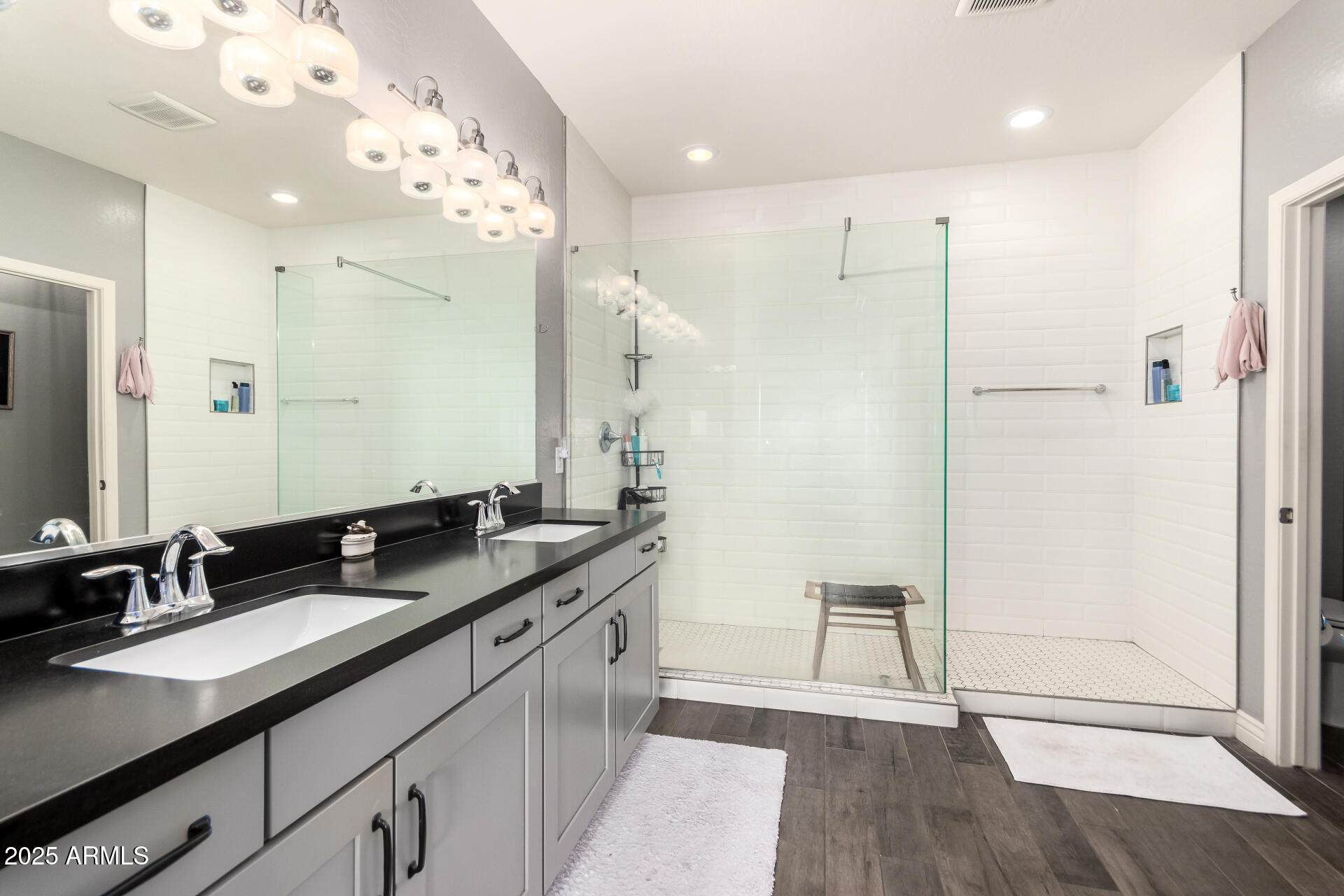 2425 West Bronco Butte Trail, Unit 2028 Phoenix, AZ 85085 - Photo 26 of 46 a spacious bathroom with a granite countertop sink mirror and a shower