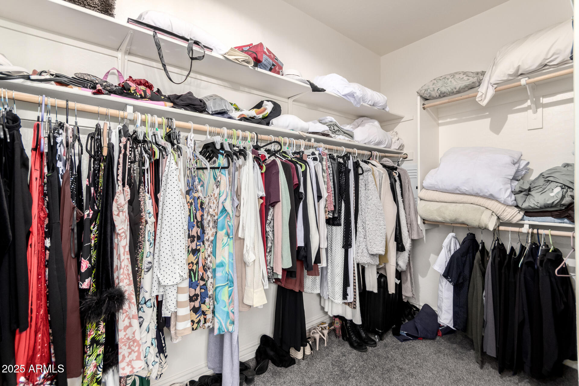 2425 West Bronco Butte Trail, Unit 2028 Phoenix, AZ 85085 - Photo 31 of 46 a view of walk in closet with clothes