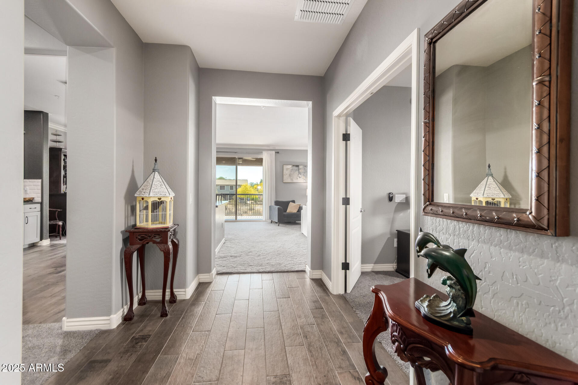 2425 West Bronco Butte Trail, Unit 2028 Phoenix, AZ 85085 - Photo 6 of 46 a view of a hallway with wooden floor and furniture