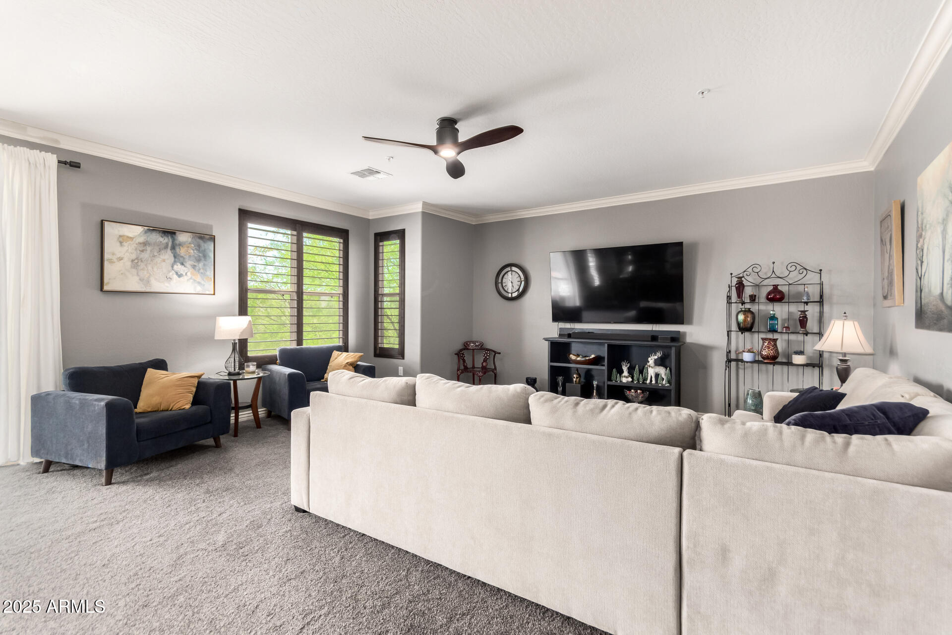 2425 West Bronco Butte Trail, Unit 2028 Phoenix, AZ 85085 - Photo 8 of 46 a living room with furniture and a flat screen tv