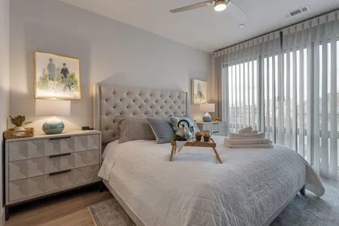 a bedroom with bed and a chandelier