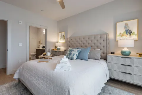 a bedroom with a bed and lamp