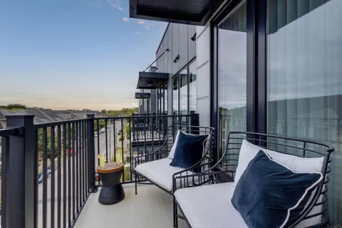 a view of balcony with furniture