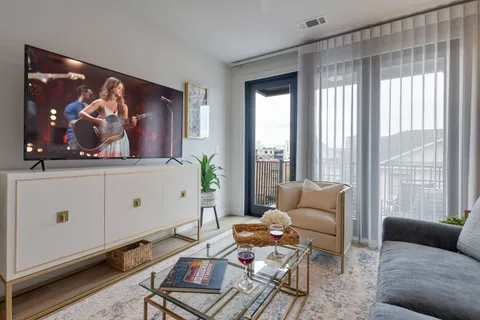a living room with furniture and a flat screen tv