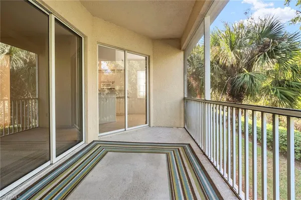 a view of a balcony with floor to ceiling windows with wooden floor