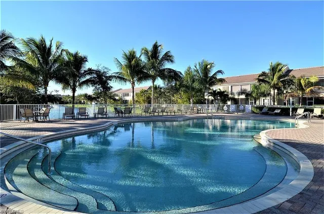 a view of swimming pool with outdoor seating