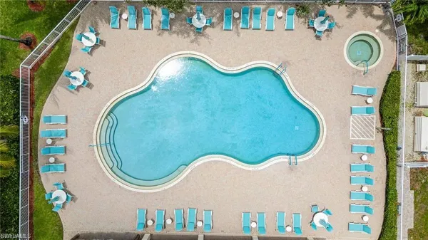 an aerial view of a house with swimming pool and garden