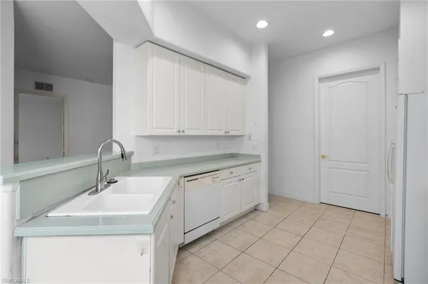 a kitchen with a sink and cabinets