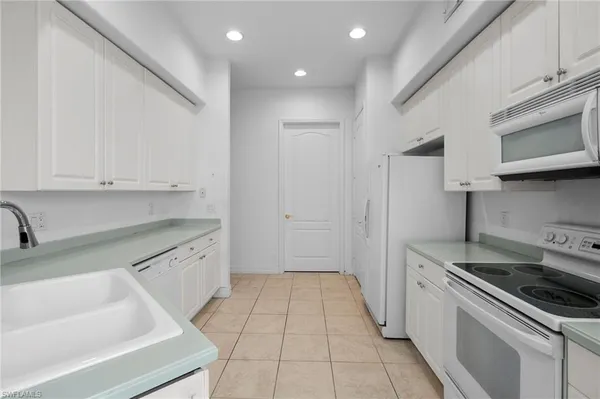 a kitchen that has a sink and a stove