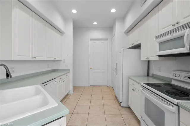 a kitchen that has a sink and a stove