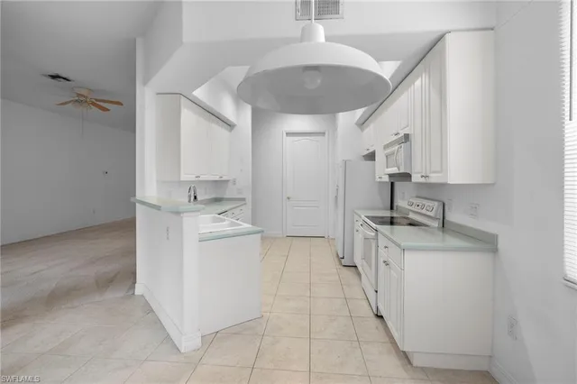 a kitchen with a sink stove and cabinets