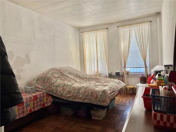a bedroom with bed and window