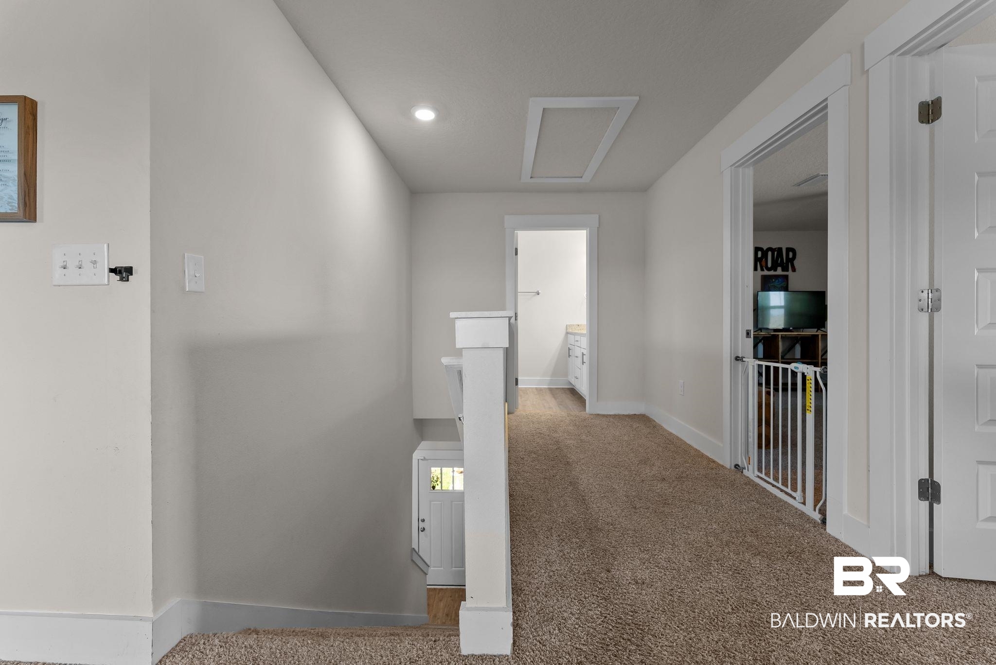 16607 Prado Loop Loxley, AL 36551 - Photo 16 of 46 Carpeted hallway featuring white trim, recessed lighting, and a visible attic access panel