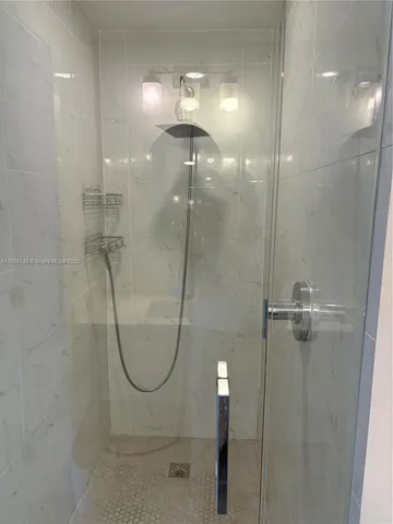 a bathroom with a glass shower door