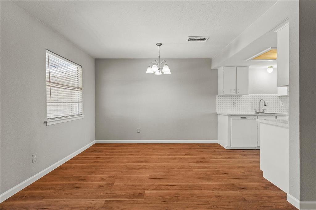 900 Wandering Way Drive Allen, TX 75002 - Photo 13 of 35 a view of empty room with wooden floor and window