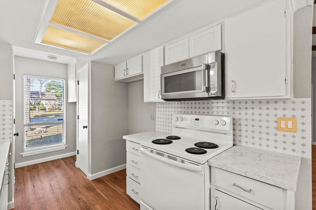 900 Wandering Way Drive Allen, TX 75002 - Photo 18 of 35 a kitchen with a stove microwave and sink
