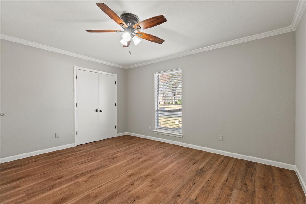 900 Wandering Way Drive Allen, TX 75002 - Photo 22 of 35 an empty room with wooden floor and windows