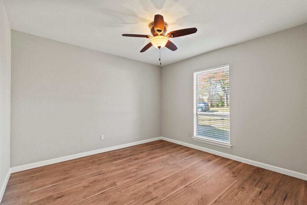900 Wandering Way Drive Allen, TX 75002 - Photo 24 of 35 wooden floor in an empty room with a window