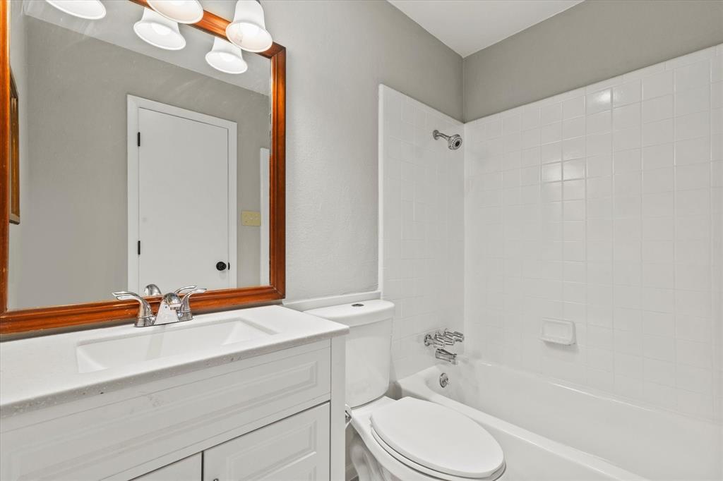 900 Wandering Way Drive Allen, TX 75002 - Photo 26 of 35 a bathroom with a sink a toilet and shower