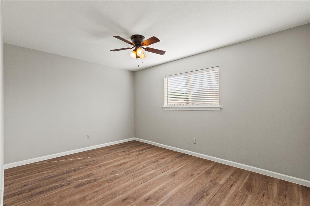 900 Wandering Way Drive Allen, TX 75002 - Photo 27 of 35 a view of a room with wooden floor and a ceiling fan
