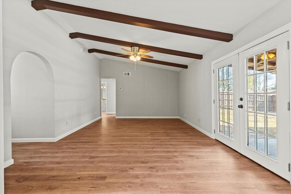 900 Wandering Way Drive Allen, TX 75002 - Photo 10 of 35 a view of an empty room with wooden floor and a window