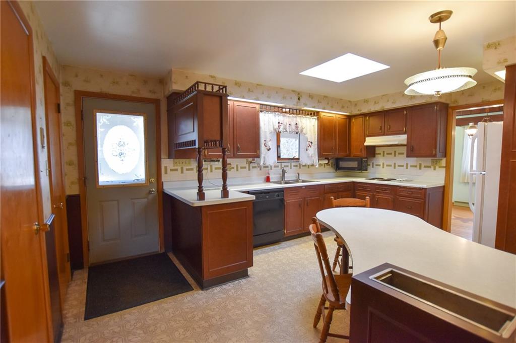 152 Oak Ridge Drive Butler, PA 16002 - Photo 5 of 12 a kitchen with a table chairs refrigerator and sink