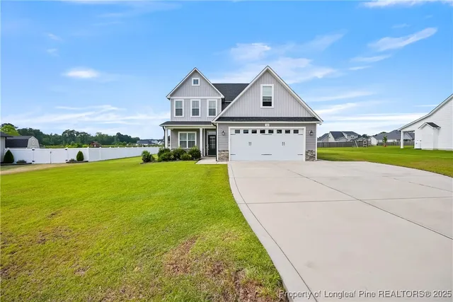 a front view of house with yard and green space