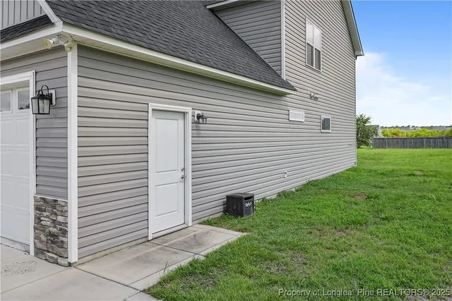 a view of a backyard with plants and large trees