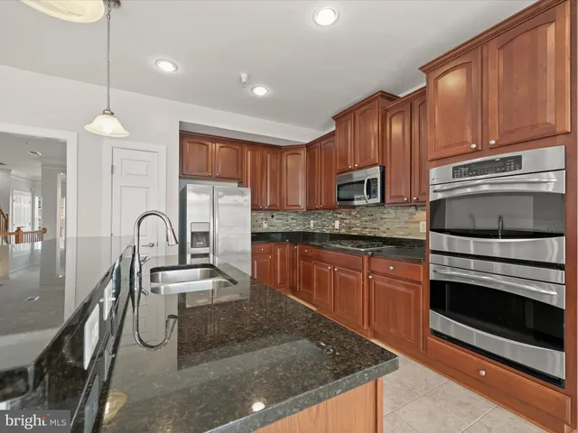 a view of kitchen with granite countertop lots of counter top space