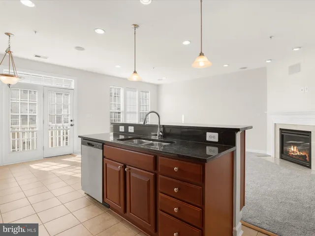 a kitchen with stainless steel appliances granite countertop a stove a sink dishwasher and a microwave